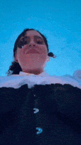 a woman wearing a black and white top with the letter a on it