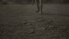a man in a leather jacket is holding a bat in his right hand