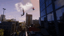 two spidermans are flying through the air in front of a city skyline