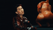 a man in a red leather jacket has a tattoo on his neck