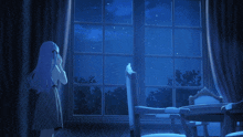 a girl stands in front of a window at night