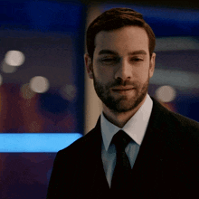 a man with a beard in a suit and tie