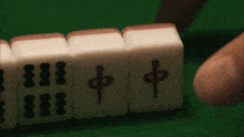 a person is playing a game of mahjong with chinese symbols