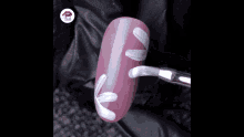 a close up of a woman 's nail with a flower design on it