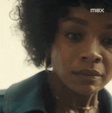 a close up of a woman 's face with a tear running down her face .