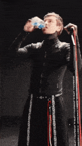 a man in a black suit is holding a red ribbon that says " thanks bro " on it