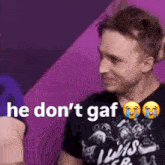 a man wearing a black shirt that says he don 't gaf