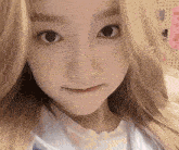 a close up of a woman 's face with long blonde hair .