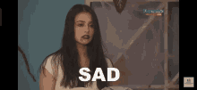 a woman with blood coming out of her mouth and the word sad below her