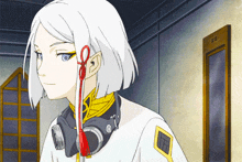 a girl with white hair and headphones around her neck stands in front of a door