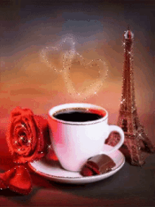 a cup of coffee next to a red rose and a chocolate bar
