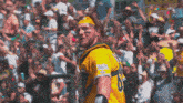 a man in a green and yellow jersey with the number 8 on the sleeve