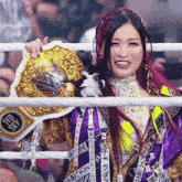 a woman in a boxing ring holding a belt that says ufc sky on it