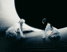 a woman in a white dress is kneeling down in front of a large black object