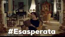 a woman sitting in a chair reading a book with the hashtag #esasperata on the screen