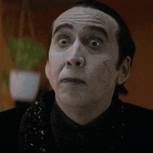 a close up of a man 's face with a surprised expression