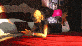 a woman is laying on her stomach on a bed with a pink lamp and a wall with a sign that says realtors network