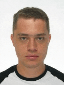 a young man is wearing a black and white shirt .