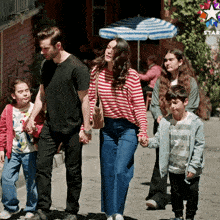a group of people are walking down a street with a star in the background