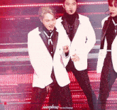 a man in a white suit stands in front of a morpheus exo kai fanpage banner