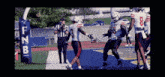 a football player with the number 8 on his jersey is being congratulated by his teammates
