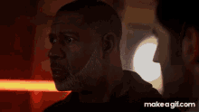 a woman is holding a gun in a dark room with a light coming out of it .