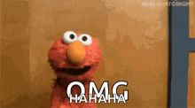 elmo from sesame street is laughing with the words `` omg hahaha '' .