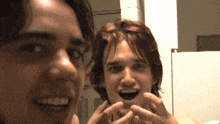 two young men are looking at each other in a mirror