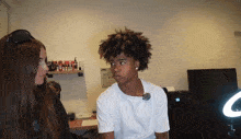 a woman and a boy are looking at each other