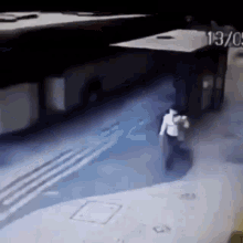 a man is walking in front of a bus with the number 137 on it