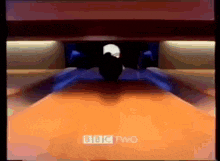 a bowling alley with bbc two written on the bottom