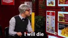 a man in a wig and glasses says i will die