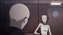 a bald man and a woman are standing in front of a door