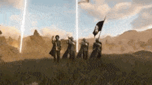 a group of people standing on top of a grass covered field holding flags .