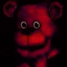 a close up of a purple teddy bear with glowing eyes .
