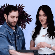 a woman wearing a white shirt with the word dickies on the front