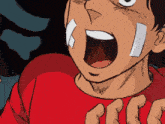 a close up of a person 's face with a red shirt on