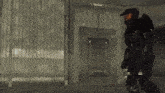 a man in a military uniform is walking through a dark room
