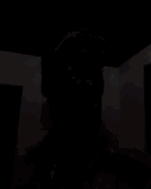 a man is sticking his tongue out in a dark room