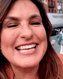 a close up of a woman 's face with a truck in the background that says thrifty