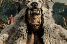 a man in a fur coat with a wolf 's head on his head