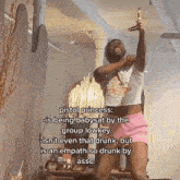 a man in a white shirt and pink shorts is dancing in a room with a chandelier .