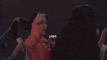 a woman in a yellow top is holding a fan and looking at the camera .