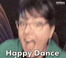 a woman with glasses is making a funny face and saying happy dance .