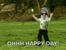 a man with a beard is dancing in a field with the words ohhh happy day
