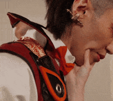a close up of a person 's ear with a red bow tie on