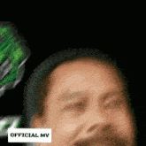 a blurry picture of a man with the words official mv on the bottom right