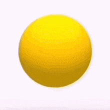 a yellow smiley face with a big smile on it is floating in the air on a gray background .