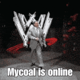 a man in a suit and tie is dancing in front of a wwe logo and the words mycoal is online