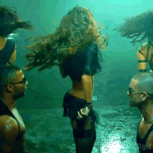 a group of people are dancing in a dark room with the word gif on the bottom right